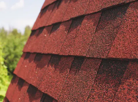Close view of asphalt shingles ready for a storm-damage inspection