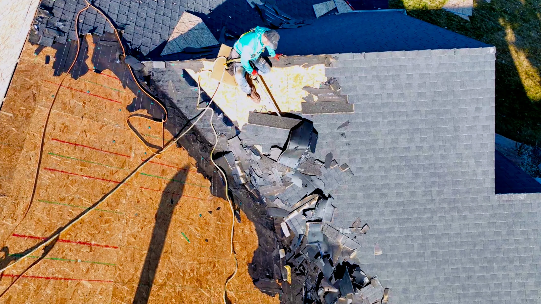 Roof replacement in progress with old shingles removed to expose the roof deck